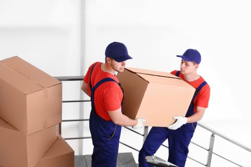 Removal team planning a house move in Finchley with packed boxes and furniture