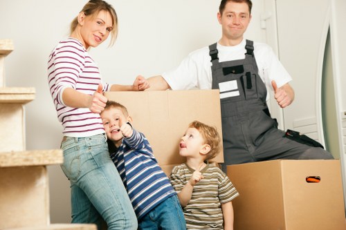 Careful loading of household items into a removals van in Finchley