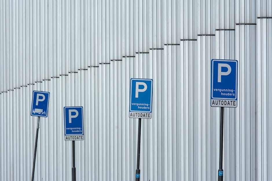 Four blue parking permit signs with white 'P' symbols and Dutch text, including 'vergunninghouders' and 'AUTODATE,' are mounted on metal poles of varying heights in front of a modern building with ver
